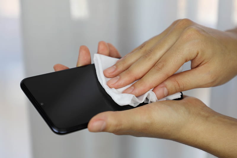 covid 19 pandemic coronavirus woman cleaning with wet wipes smart phone screen disinfect against coronavirus disease 2019 outbreak